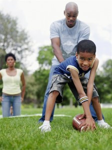 man and boy playing football