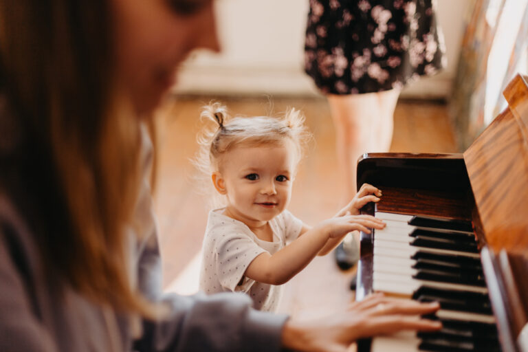 Mum and daughter playing piano